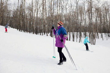 Fototapeta na wymiar Portrait of a senior skier in a winter forest