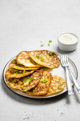 Zucchini fritters with sour cream sauce. Space for text.