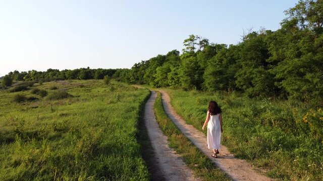 Girl walking on a country road