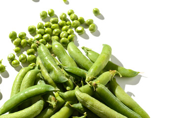 green peas and pods on a white background