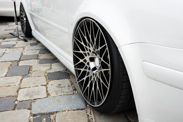 Modern car wheel with a light alloy disc. Low chassis.
