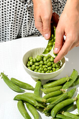 green peas and pods on a white background