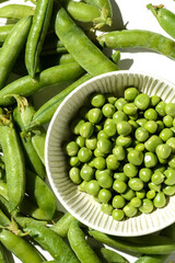 green peas and pods on a white background