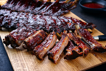 Barbecue pork spare loin ribs St Louis cut with hot honey chili marinade served as close-up on a...