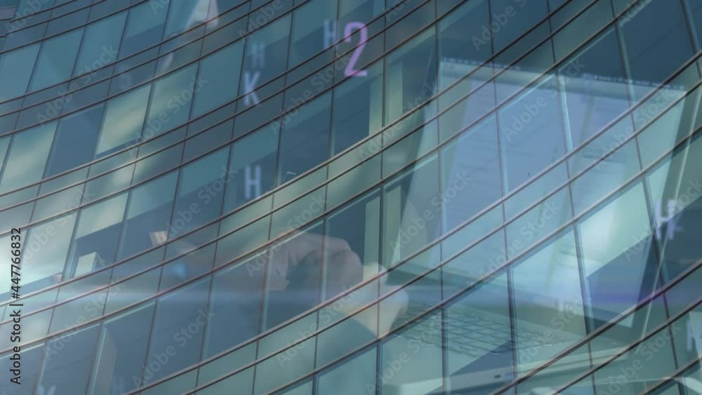 Poster multiple changing numbers and alphabets over mid section of person using laptop over tall building