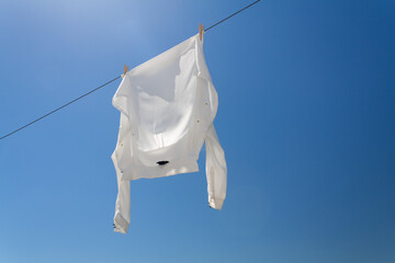 White shirt hanging to dry on clothes line