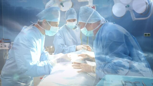 Digital composition of team of surgeons performing surgery at hospital against clouds in the sky