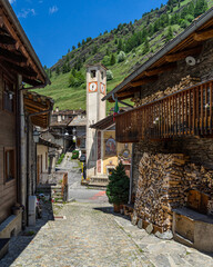 View of alpine houses and church in Pontechianale, a typical village in Varaita Valley, Piedmont, Italy