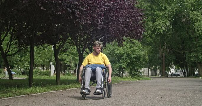 Young man in wheelchair outdoors