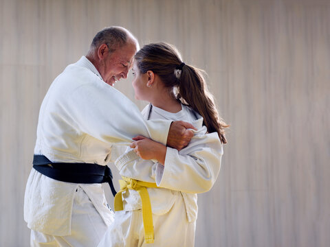 Young yellow belt  judo girl sparring with old sensei