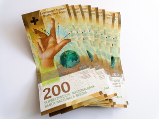 pile of twohundred swiss francs on white background - heap of money on white background