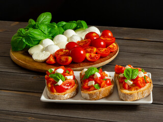 Caprese sandwich. Bruschetta caprese with ingredients: tomato, basil and mozzarella. Traditional Italian summer food.