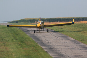 Crop duster landing on a small air strip to re-fuel and reload chemicals to spray on the crops