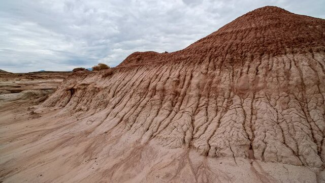 Erosion in the red mars like desert landscape in Utah in timelapse as clouds move through the sky.