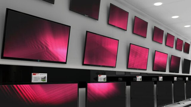 Interior of electronics store with synchronized video playing on screens of multiple televisions