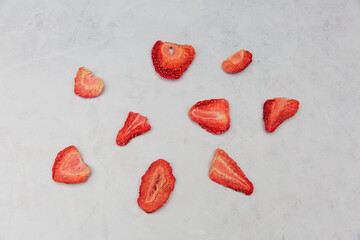 Freeze dried strawberries on a marble background