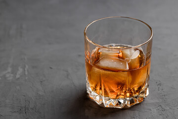 whiskey glass on a concrete background with copy space. alcohol addiction concept
