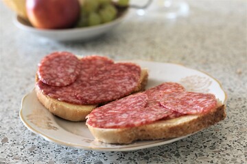 Closeup sausage sandwich on plate salami bread