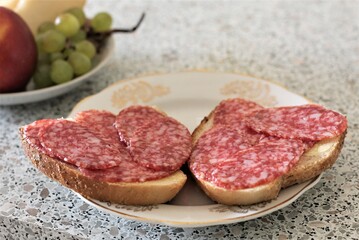 Closeup sausage sandwich on plate salami bread