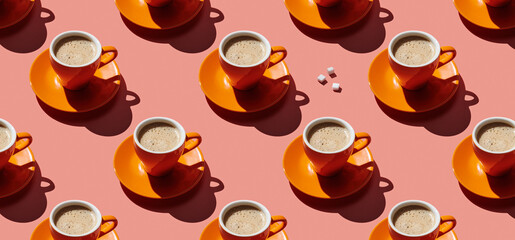 Pattern of coffee mugs on pink pastel background