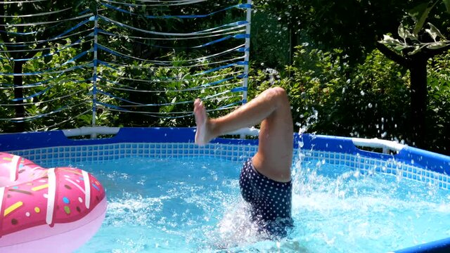 Girl child in swimming mask dive in outdoor pool on sunny summer day, diving