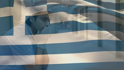 Digital composition of greece flag waving against stressed caucasian male health worker at hospital - Powered by Adobe