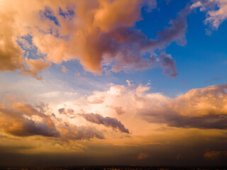 Aerial view on rain clouds at sunset over the city