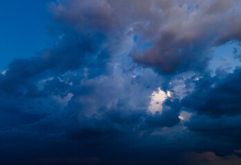 Aerial view on rain clouds at sunset over the city