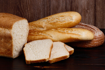 baked bread and baguette on wooden table background