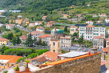 Fototapeta na wymiar View of the Medieval Church of Saint Anthony clock tower and city of Dolceacqua, Italy, from the ancient hilltop castle.