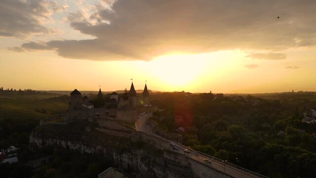 Aerial drone view of medieval castle at sunset in Kamianets-Podilskyi town