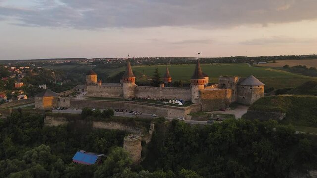 Aerial drone view of medieval castle at sunset in Kamianets-Podilskyi town