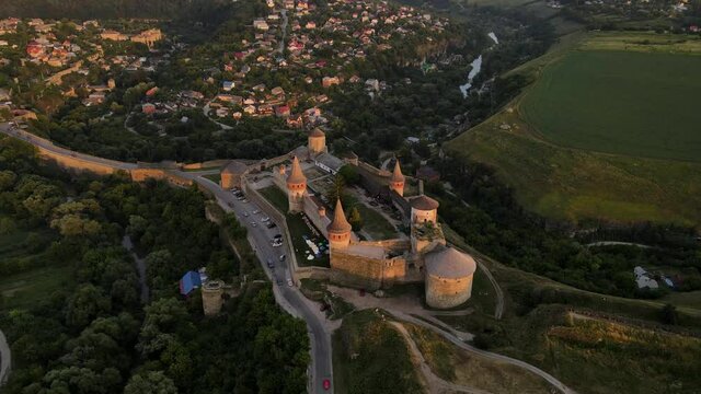 Aerial drone view of medieval castle at sunset in Kamianets-Podilskyi town