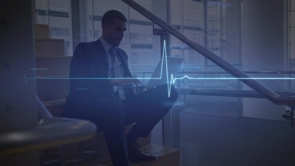 Animation of heart beat rate monitor over business man using laptop - Powered by Adobe