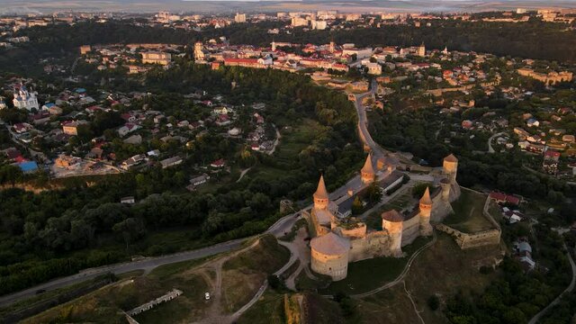 Aerial drone view of medieval castle at sunset in Kamianets-Podilskyi town