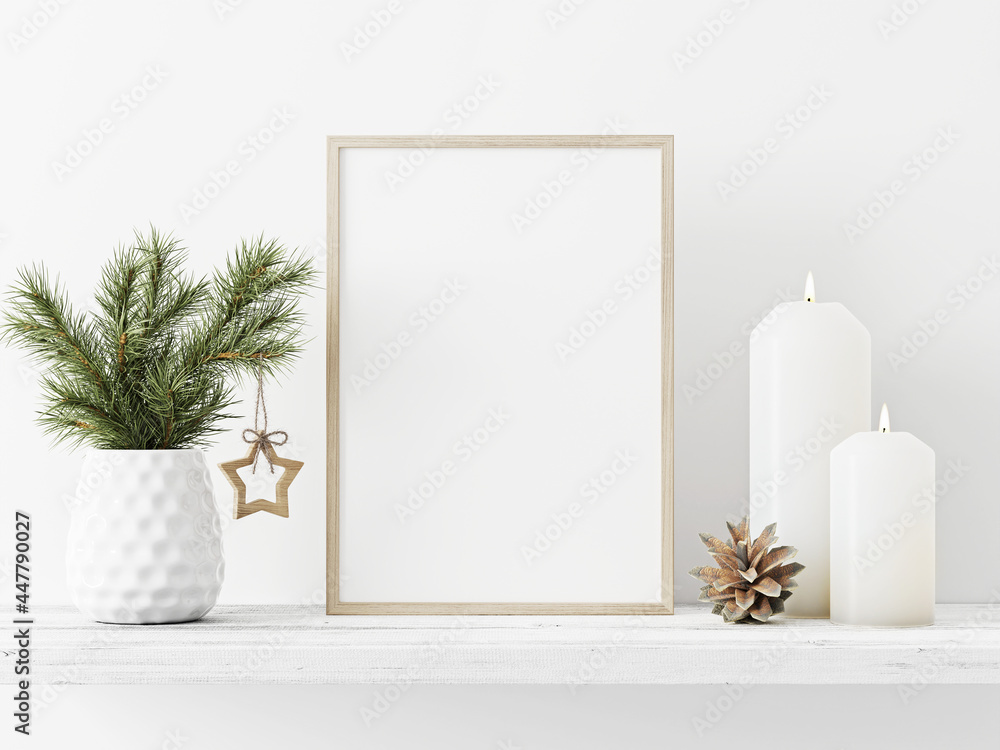 Poster small vertical wooden frame mockup with pine branch in vase, pinecone, star and candles on empty whi