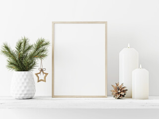 Small vertical wooden frame mockup with pine branch in vase, pinecone, star and candles on empty white wall background. Minimal Christmas interior decoration. A4, A3 format. 3d rendering, illustration