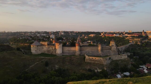 Aerial drone view of medieval castle at sunset in Kamianets-Podilskyi town