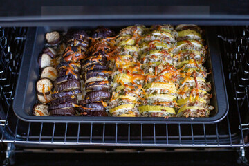 Oven baked zucchini and eggplant with cheese and rice. Vegetable casserole. Vegetarian dish