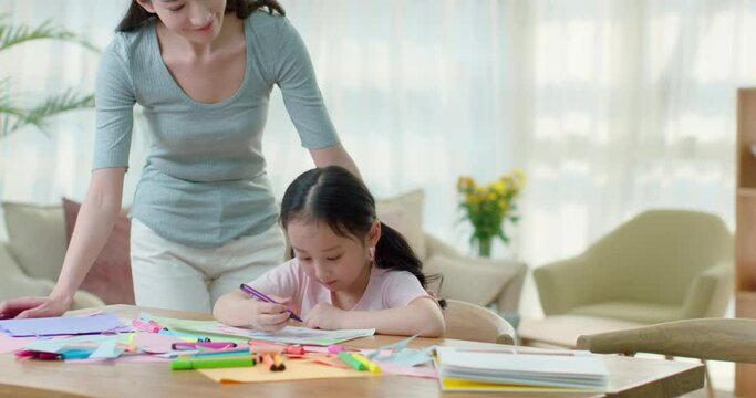 Happy mother and daughter drawing at home,4K