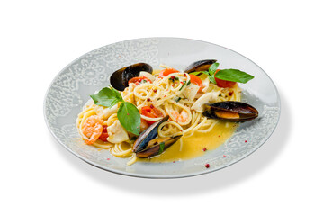 Pasta spaghetti with seafood, shrimps, mussels, tomatoes and basil isolated on white