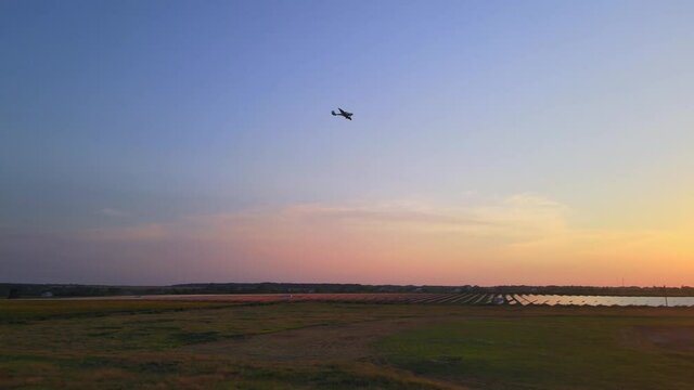 Small private airplane with propeller in front flying in blue sky at sunset. Private commercial flights by aircraft. Training pilots to drive, educational concept. HRD video