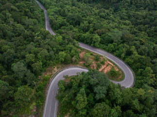 aerial photograph The mountain road that curves alternately on the Phu Phan Mountain Range. The road has traffic that is not congested. Sakon Nakhon Province, Thailand