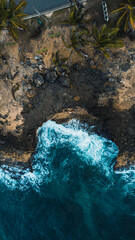 abstract puzzle drone view of ocean clashing with rocks 