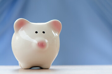 piggy bank for investment ,save money or retire in future with blue background and copy space