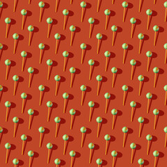 Photo in the form of a seamless pattern. Candy on a stick with shadows on a colored orange background. High quality photo
