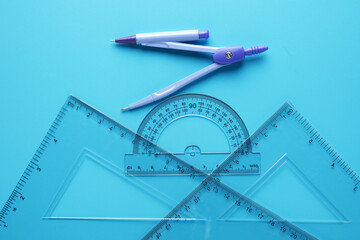 A picture of geometry set with copyspace sticky note on blue background. Engineering and...