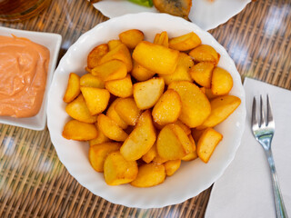 Delicious spanish patatas bravas tapas, fried pieces of potatoes