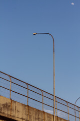 a lamppost standing upright under the moon
