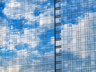 Fototapeta na wymiar Clouds reflection in the office building.